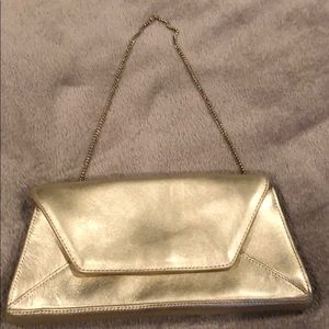 Gold, leather clutch purse.